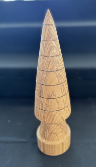 Wooden conical sculpture with spiral grooves and a rounded base.