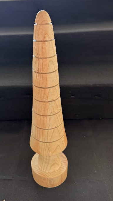 Wooden sculpture shaped like a tapered cone with distinct horizontal grooves.