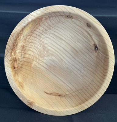 A wooden bowl with a smooth surface and natural grain pattern.