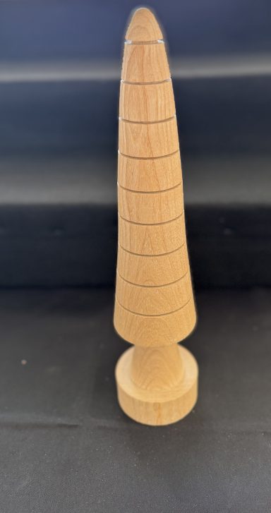 Wooden conical sculpture with a textured, spiral design on a circular base.