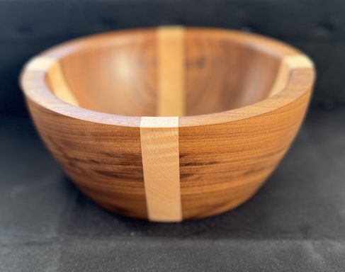Wooden bowl with a smooth finish and light coloured wooden band across the centre.