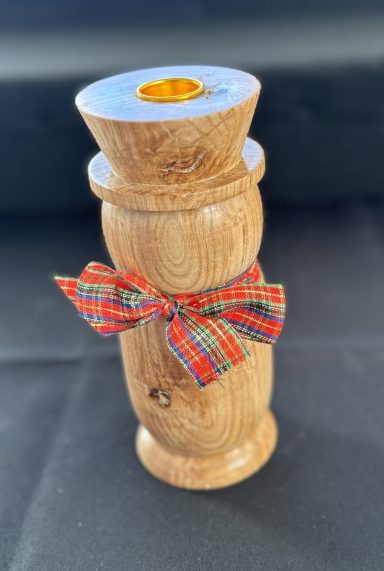 Wooden ornament with a bow, featuring a smooth finish and natural wood grain.