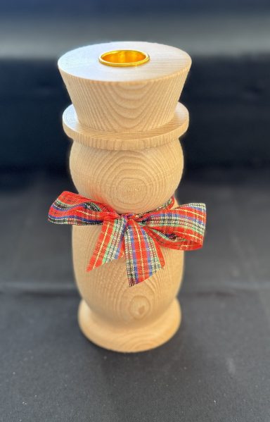 A wooden candle holder with a checkered ribbon around the base.