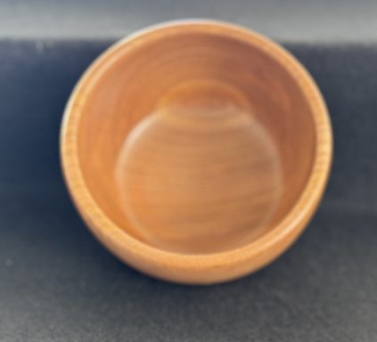 A wooden bowl with a smooth, polished interior and a natural finish.