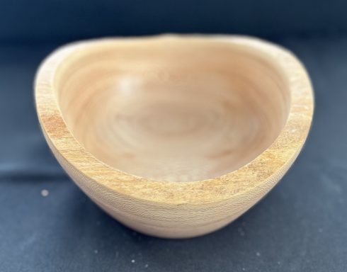 Light wooden bowl with a smooth interior and a rustic, curved design.