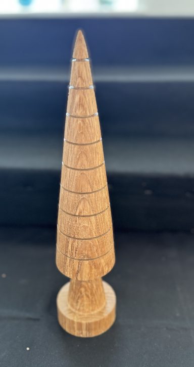 Wooden conical Christmas tree decoration with engraved patterns and a circular base.