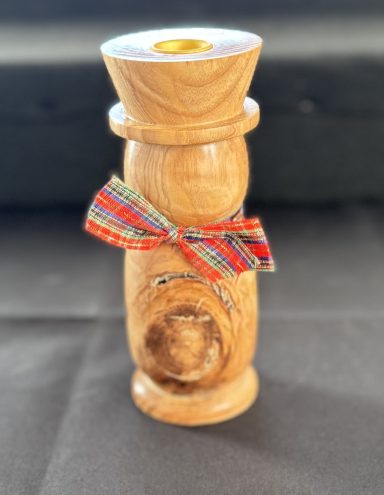 Wooden figurine with a ribbon, featuring a polished finish and cylindrical shape.