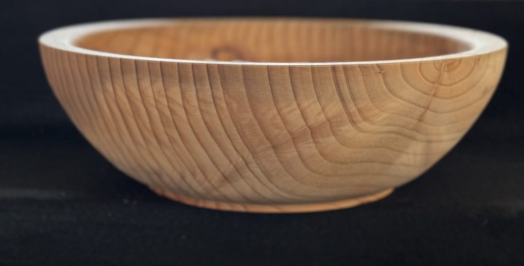 A wooden bowl with a smooth finish and distinct grain pattern.