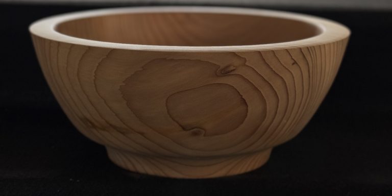Light wooden bowl with a smooth finish and a subtle grain pattern.