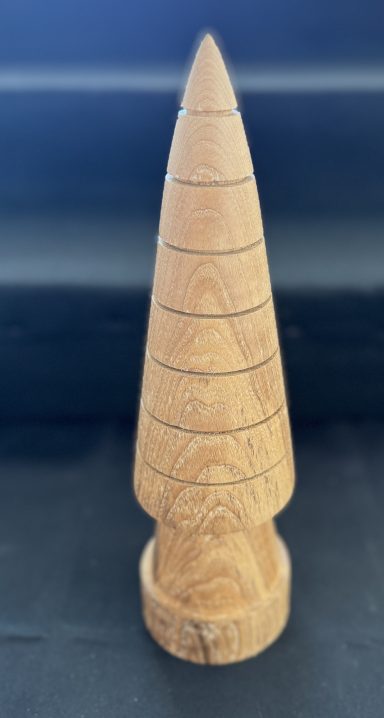 Wooden decorative item shaped like a conical tree with horizontal rings.