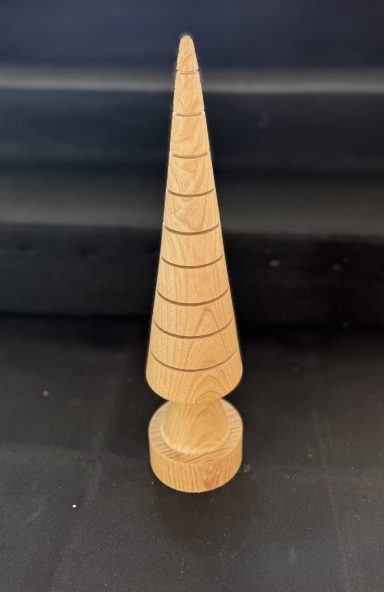 Wooden cone-shaped object with spiral grooves, sitting on a round base.