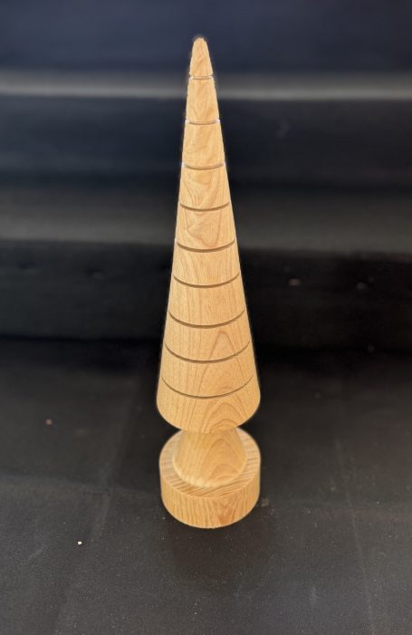 Wooden cone-shaped object with spiral grooves, sitting on a round base.