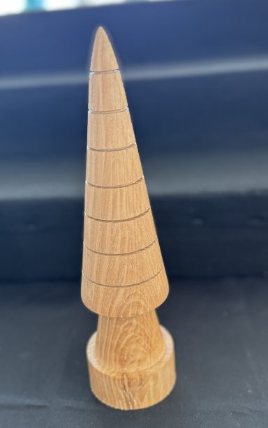 A wooden conical object with horizontal grooves and a circular base.