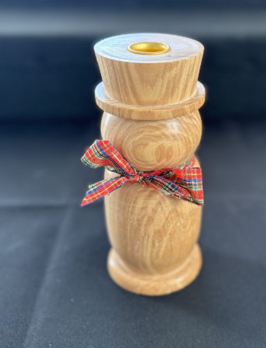 Wooden candle holder with a decorative ribbon around the neck.