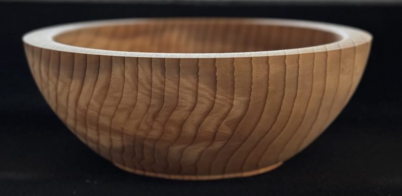 Wooden bowl with a smooth finish and visible grain pattern.