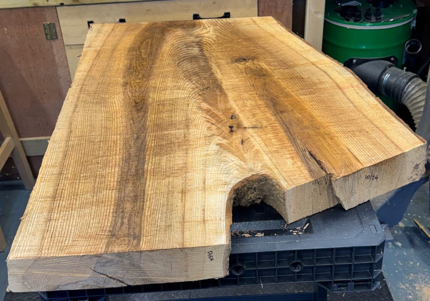 A large, well-finished wooden slab with natural grain patterns.